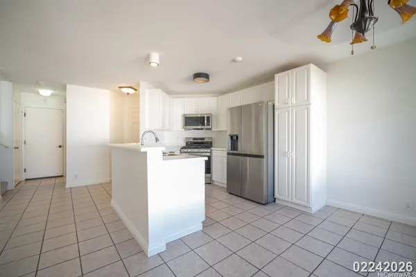 a kitchen with a refrigerator and a sink