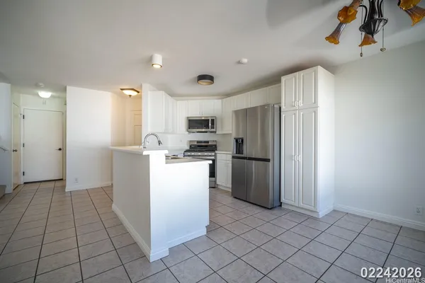 a kitchen with refrigerator and cabinets