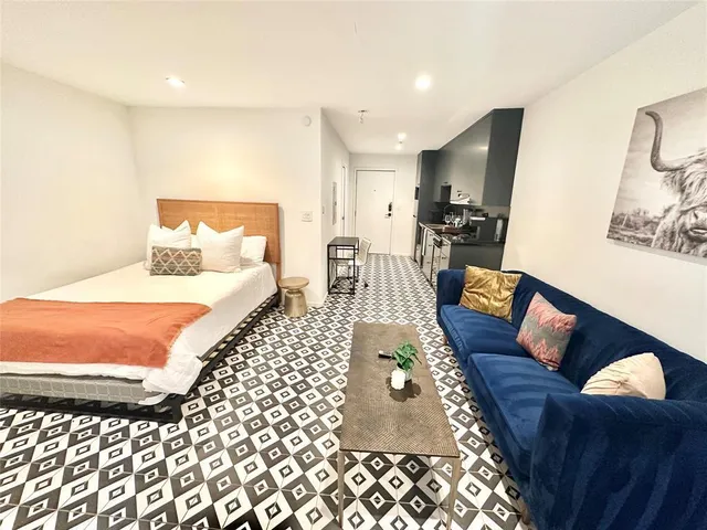 a living room with furniture and a rug