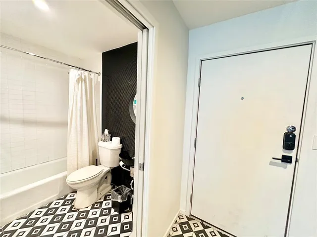 a bathroom with a toilet and a shower
