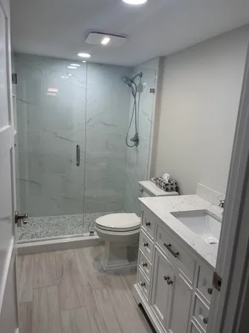 a bathroom with a toilet and a shower