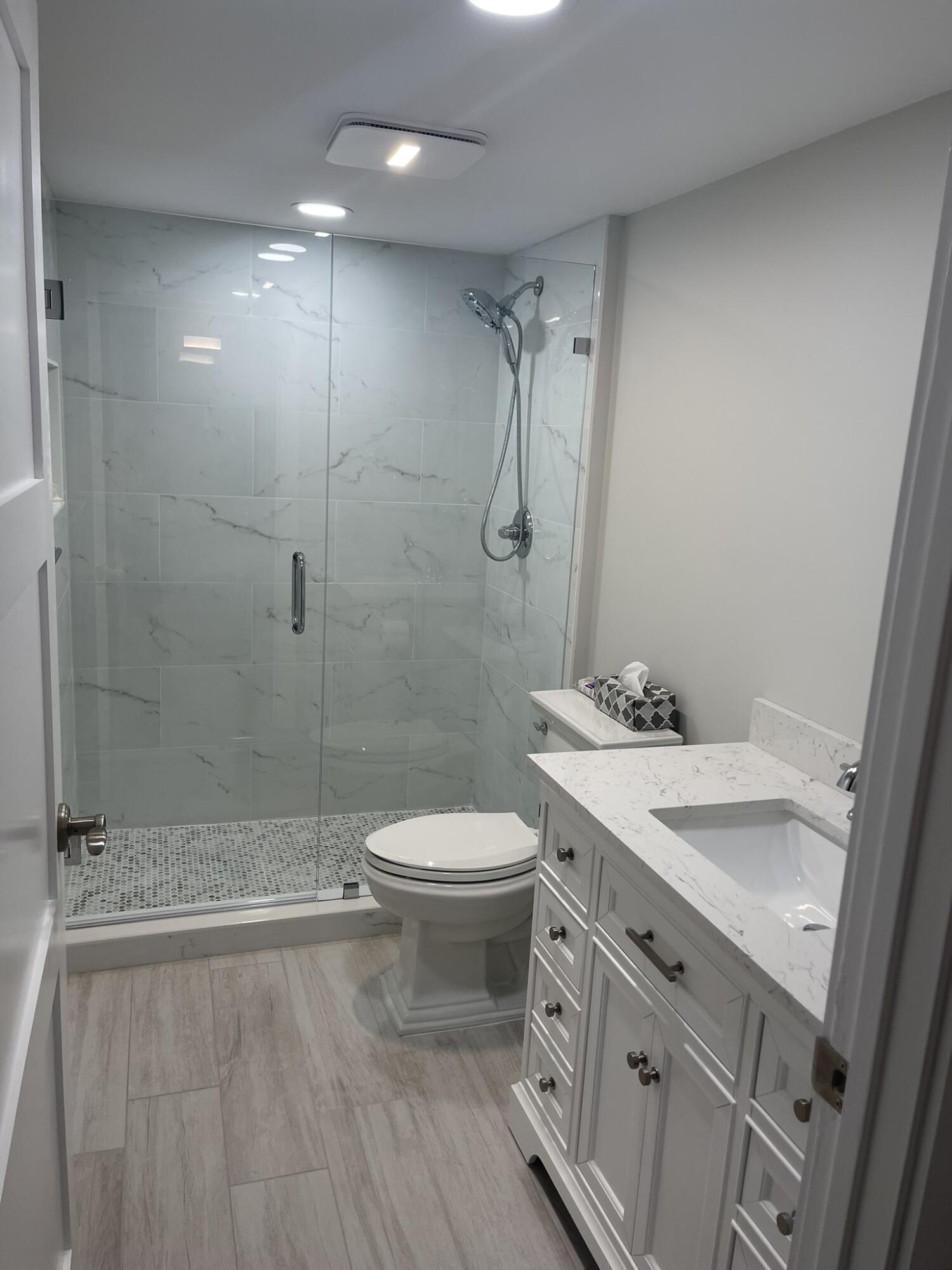 401 South Seas Drive, Unit 503 Jupiter, FL 33477 - Photo 7 of 11 a bathroom with a sink a toilet and shower