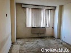 118-18 Union Turnpike, Unit 7D Queens, NY 11415 - Photo 5 of 6 a view of an empty room with a window