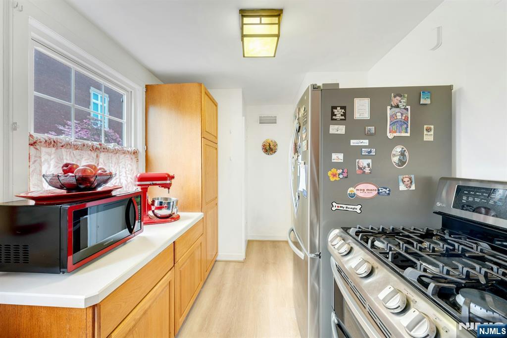 17 Brookdale Road Bloomfield, NJ 07003 - Photo 11 of 27 a kitchen with stainless steel appliances granite countertop a stove and a refrigerator