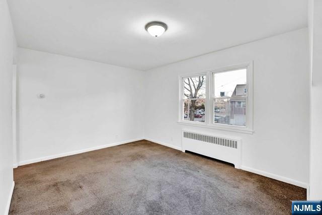 1010 Ponsi Street, Unit 2 Fort Lee, NJ 07024 - Photo 5 of 13 an empty room with windows