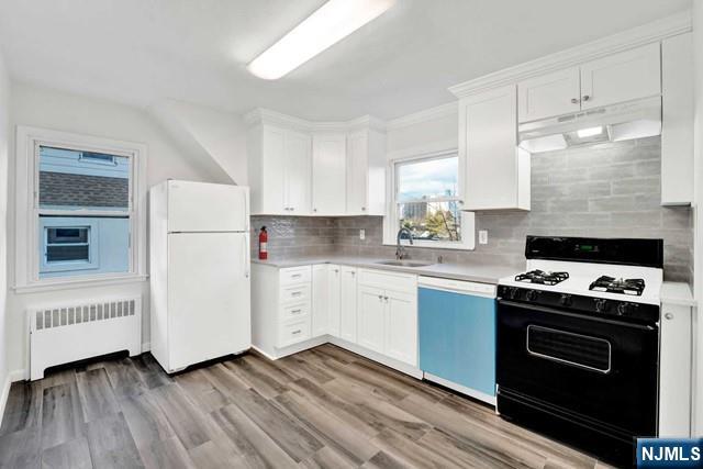 1010 Ponsi Street, Unit 2 Fort Lee, NJ 07024 - Photo 6 of 13 a kitchen with a stove a sink and a refrigerator
