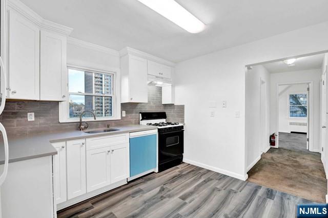 1010 Ponsi Street, Unit 2 Fort Lee, NJ 07024 - Photo 7 of 13 a kitchen with a sink stove and cabinets