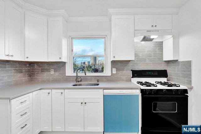 1010 Ponsi Street, Unit 2 Fort Lee, NJ 07024 - Photo 8 of 13 a kitchen with white cabinets and appliances
