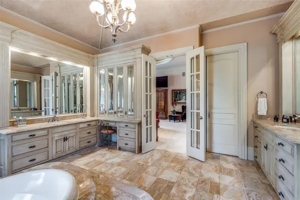 a spacious bathroom with a double vanity sink a large mirror and a bathtub