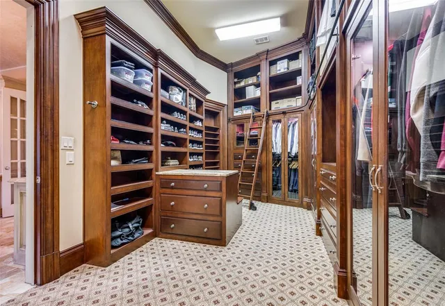 a view of walk in closet and bedroom