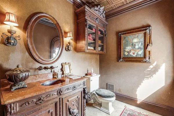 a bathroom with a toilet a sink and a mirror