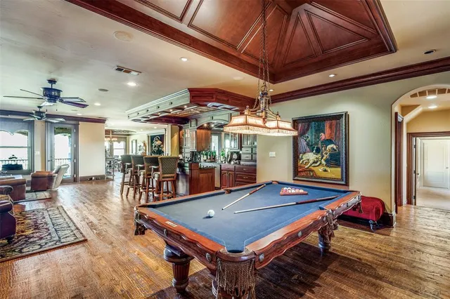 a room with pool table table and chairs