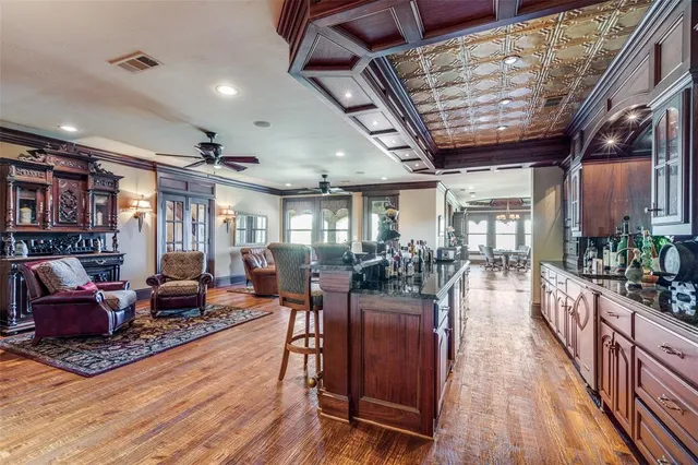 a living room with lots of furniture and wooden floors
