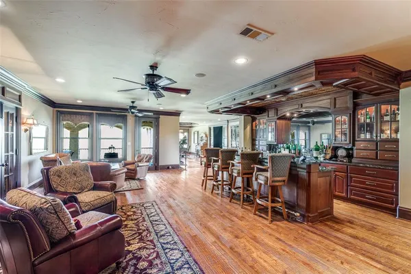 a living room filled with furniture hardwood floor and a chandelier