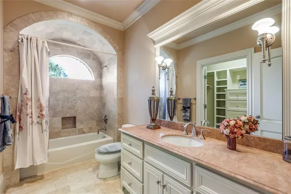 a bedroom with a bed a couch and a window