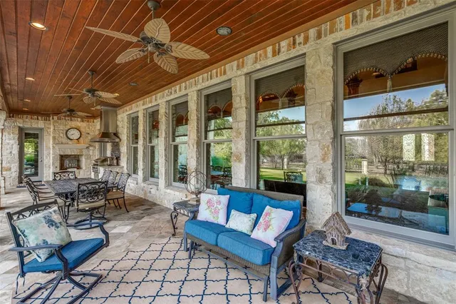 a view of a porch with furniture and a backyard