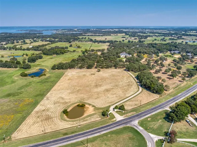 an aerial view of residential houses with outdoor space and swimming pool
