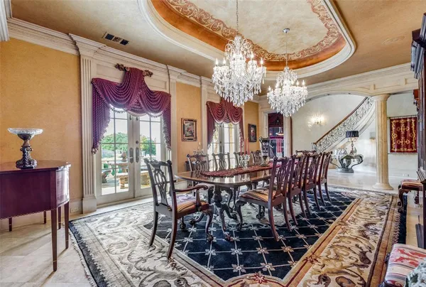 a view of a dining room with furniture a chandelier and wooden floor