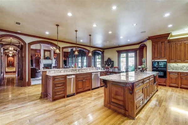 a kitchen with stainless steel appliances granite countertop a stove and a large kitchen island