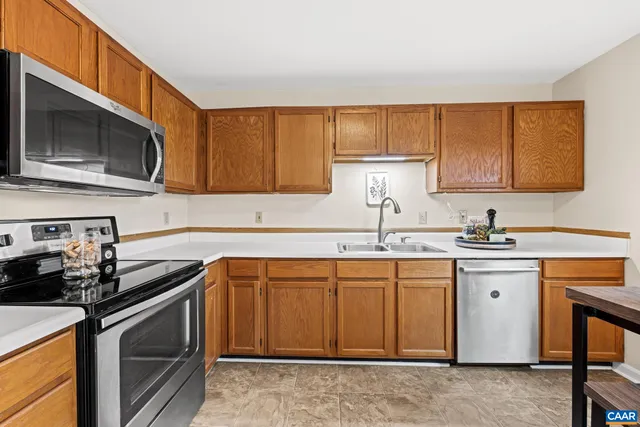a kitchen with stainless steel appliances granite countertop a sink stove and microwave