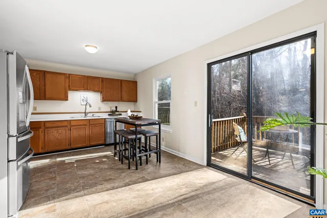 a kitchen with a table chairs refrigerator and cabinets