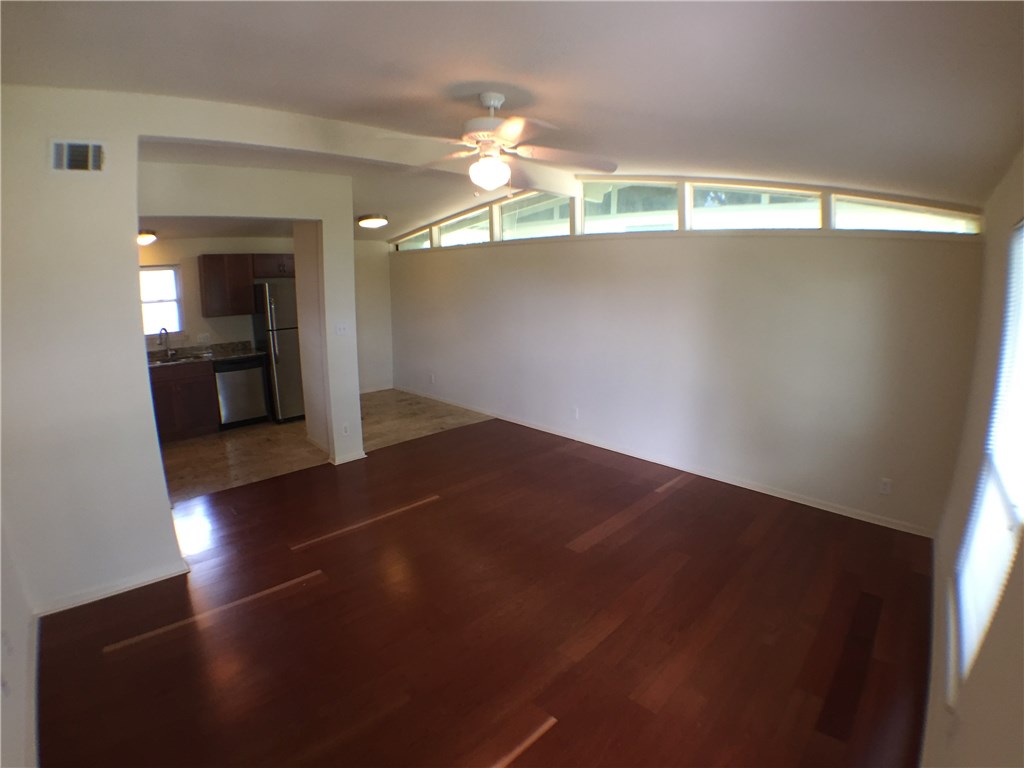 2703 Swisher Street, Unit 202A Austin, TX 78705 - Photo 3 of 14 wooden floor in an empty room with a window