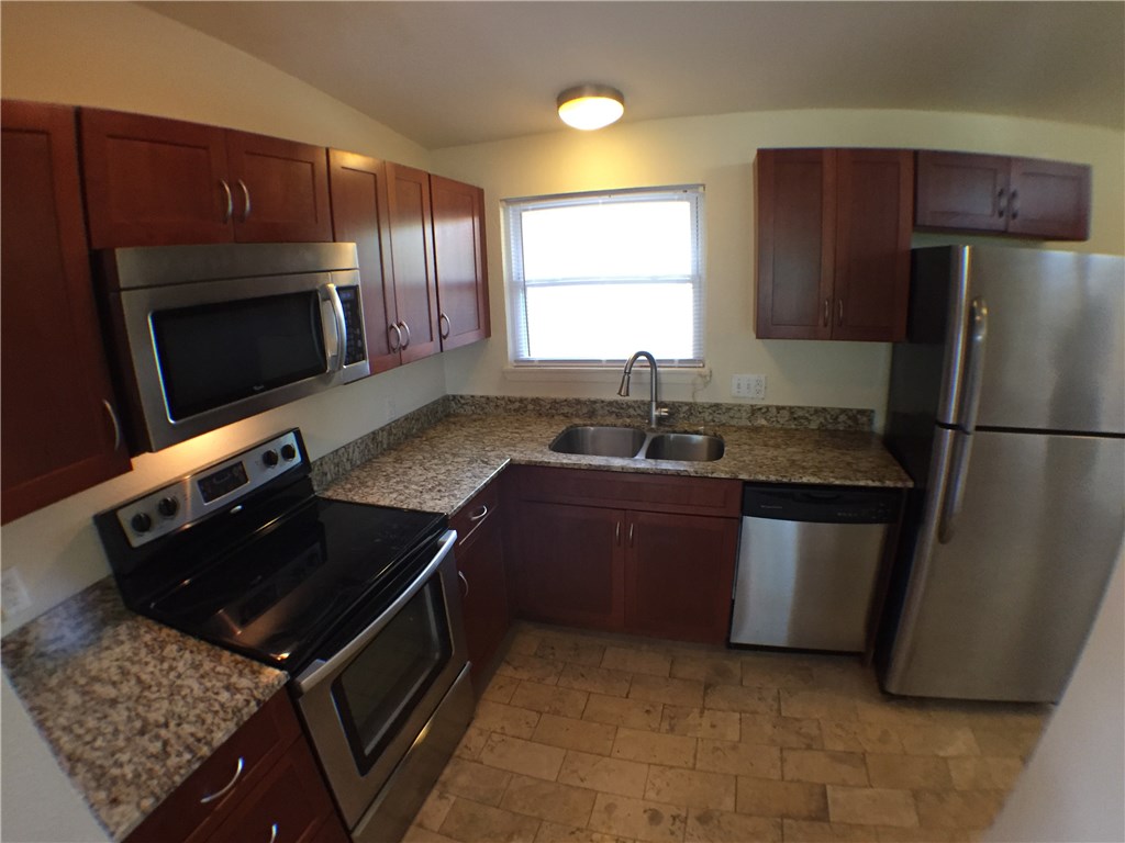 2703 Swisher Street, Unit 202A Austin, TX 78705 - Photo 5 of 14 a kitchen with a refrigerator stove and microwave