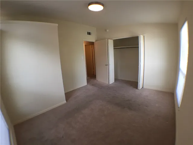 a view of an empty room and a window