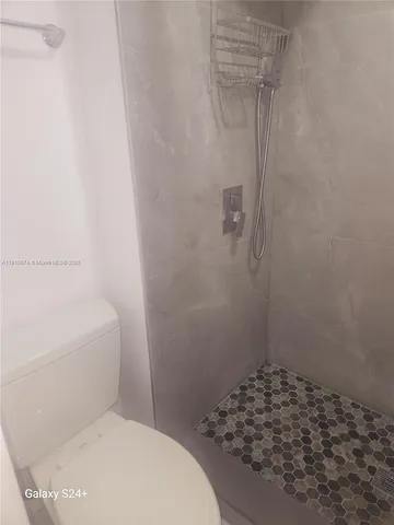 a bathroom with a toilet and shower