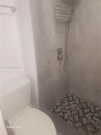 a bathroom with a toilet and shower