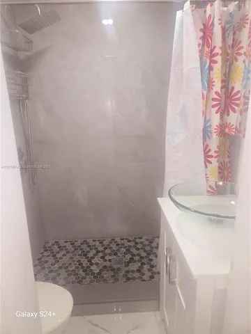 a bathroom with a sink and toilet