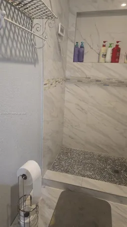 a bathroom with a bathtub and shower