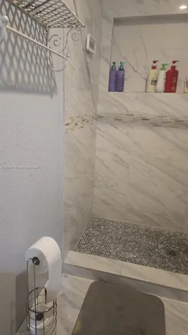 a bathroom with a bathtub and shower