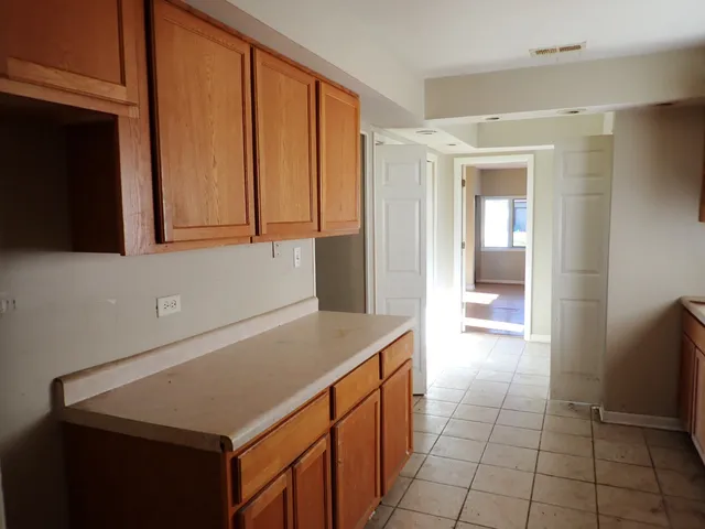 a kitchen with a sink and a refrigerator