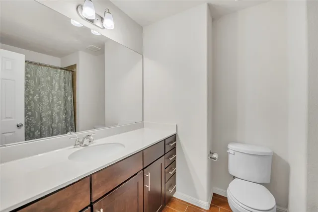 an empty room with a window and a ceiling fan