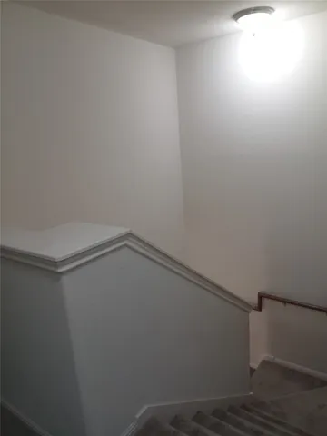 a view of a house with brick walls and a yard with plants