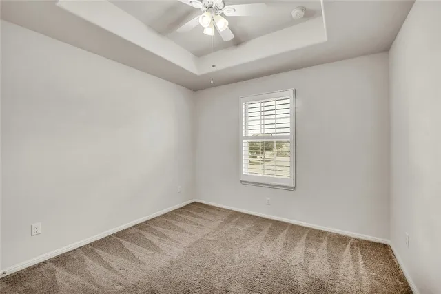 a view of a house with brick walls and a yard with plants