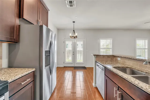 a kitchen with a sink stove and refrigerator