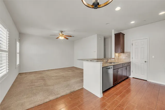 a view of a kitchen with a sink and a refrigerator