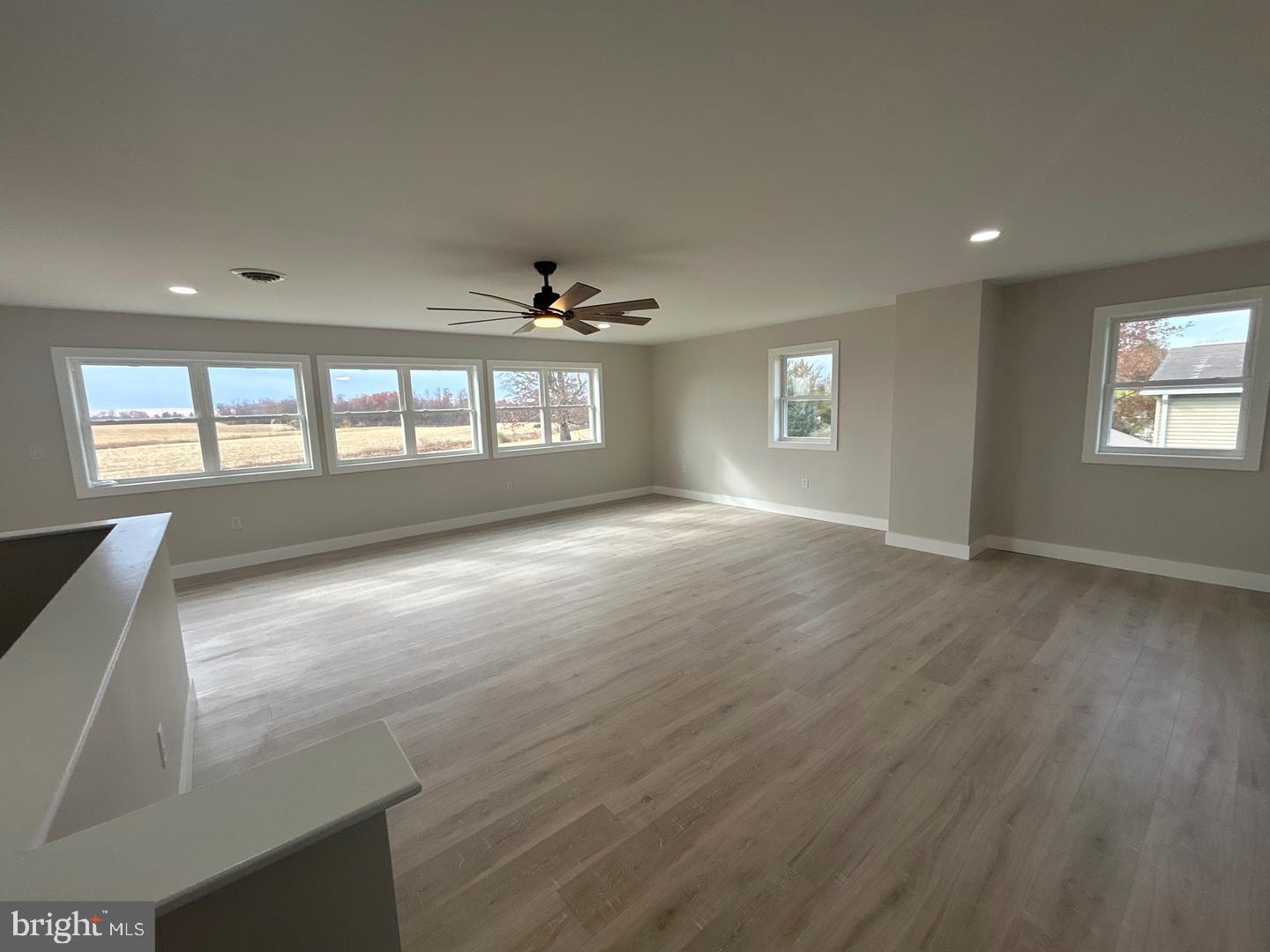 1133 Gayman Road Chambersburg, PA 17202 - Photo 11 of 33 an empty room with wooden floor and windows