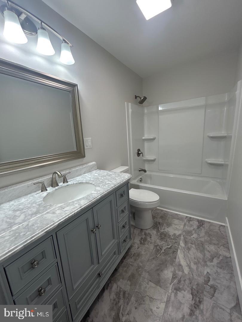 1133 Gayman Road Chambersburg, PA 17202 - Photo 13 of 33 a bathroom with a granite countertop sink toilet and shower