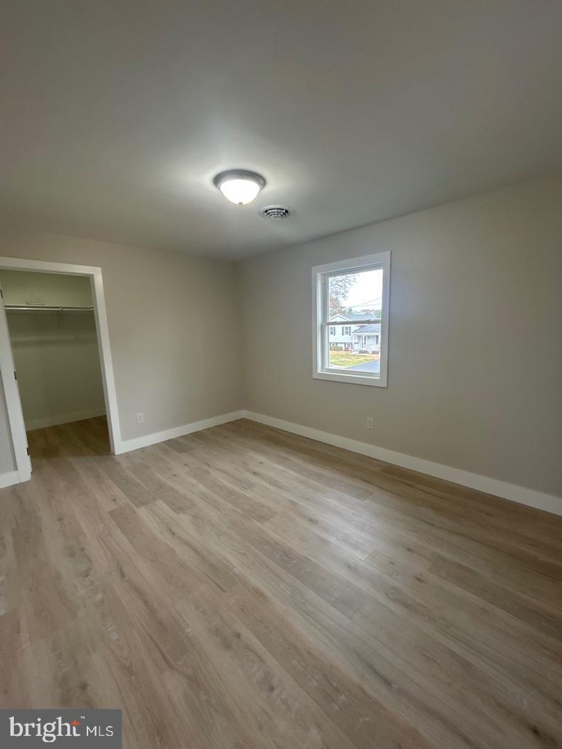 1133 Gayman Road Chambersburg, PA 17202 - Photo 18 of 33 an empty room with wooden floor and windows