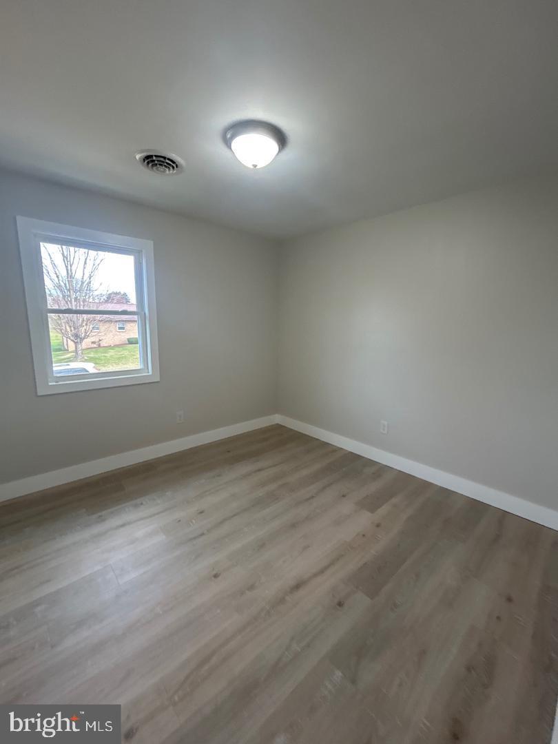 1133 Gayman Road Chambersburg, PA 17202 - Photo 20 of 33 an empty room with wooden floor and windows