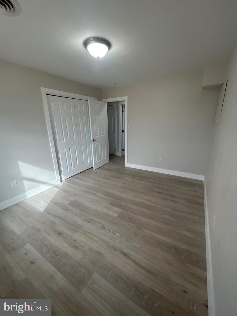 1133 Gayman Road Chambersburg, PA 17202 - Photo 21 of 33 an empty room with wooden floor and windows