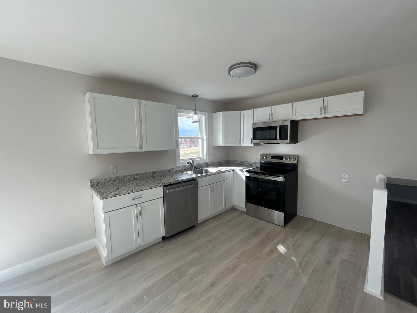 1133 Gayman Road Chambersburg, PA 17202 - Photo 3 of 33 a kitchen with a sink cabinets and wooden floor