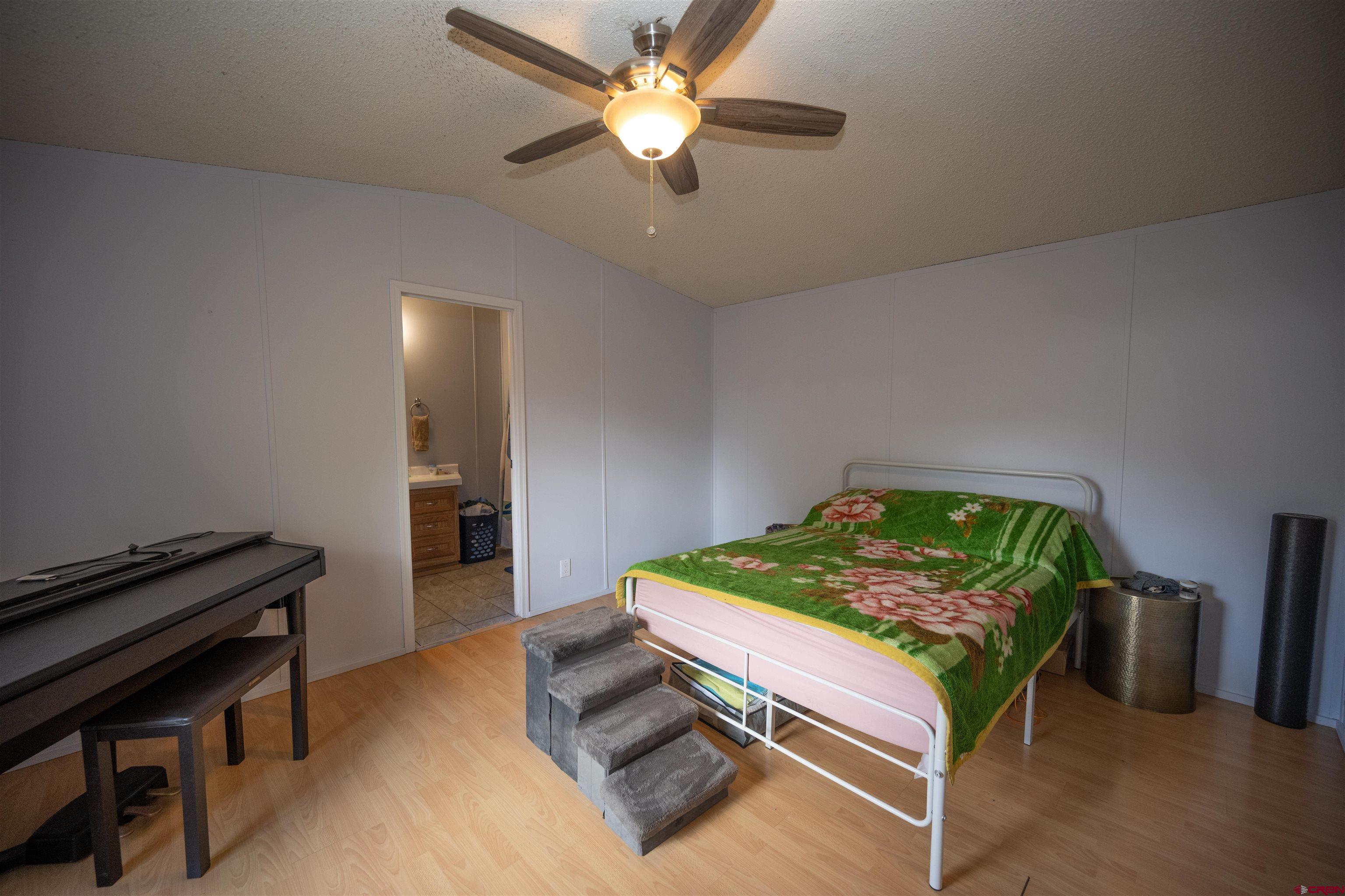 2 Mulberry Way Durango, CO 81301 - Photo 20 of 40 a bedroom with bed and a chandelier