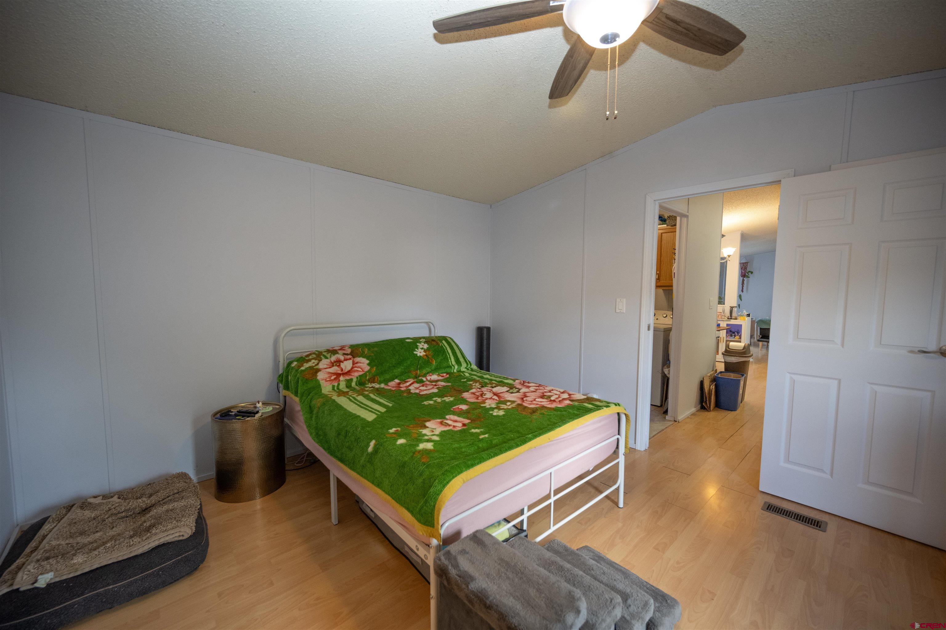2 Mulberry Way Durango, CO 81301 - Photo 21 of 40 a bedroom with a bed and a chandelier