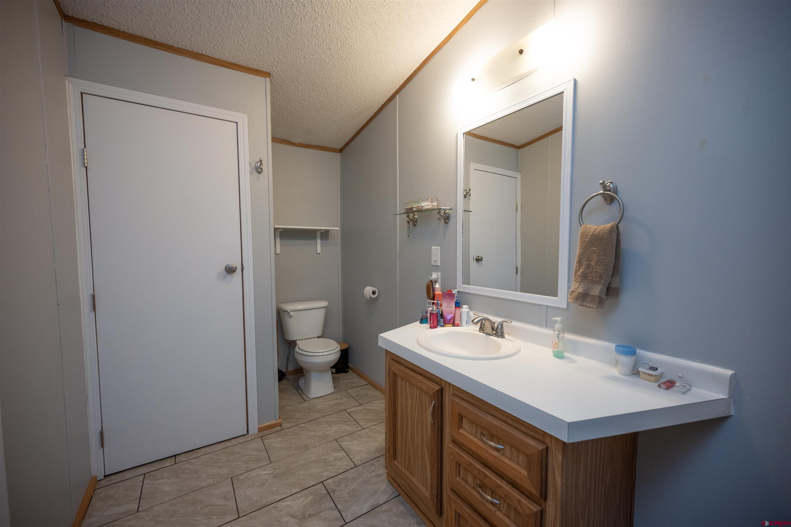 2 Mulberry Way Durango, CO 81301 - Photo 23 of 40 a bathroom with a sink and a mirror