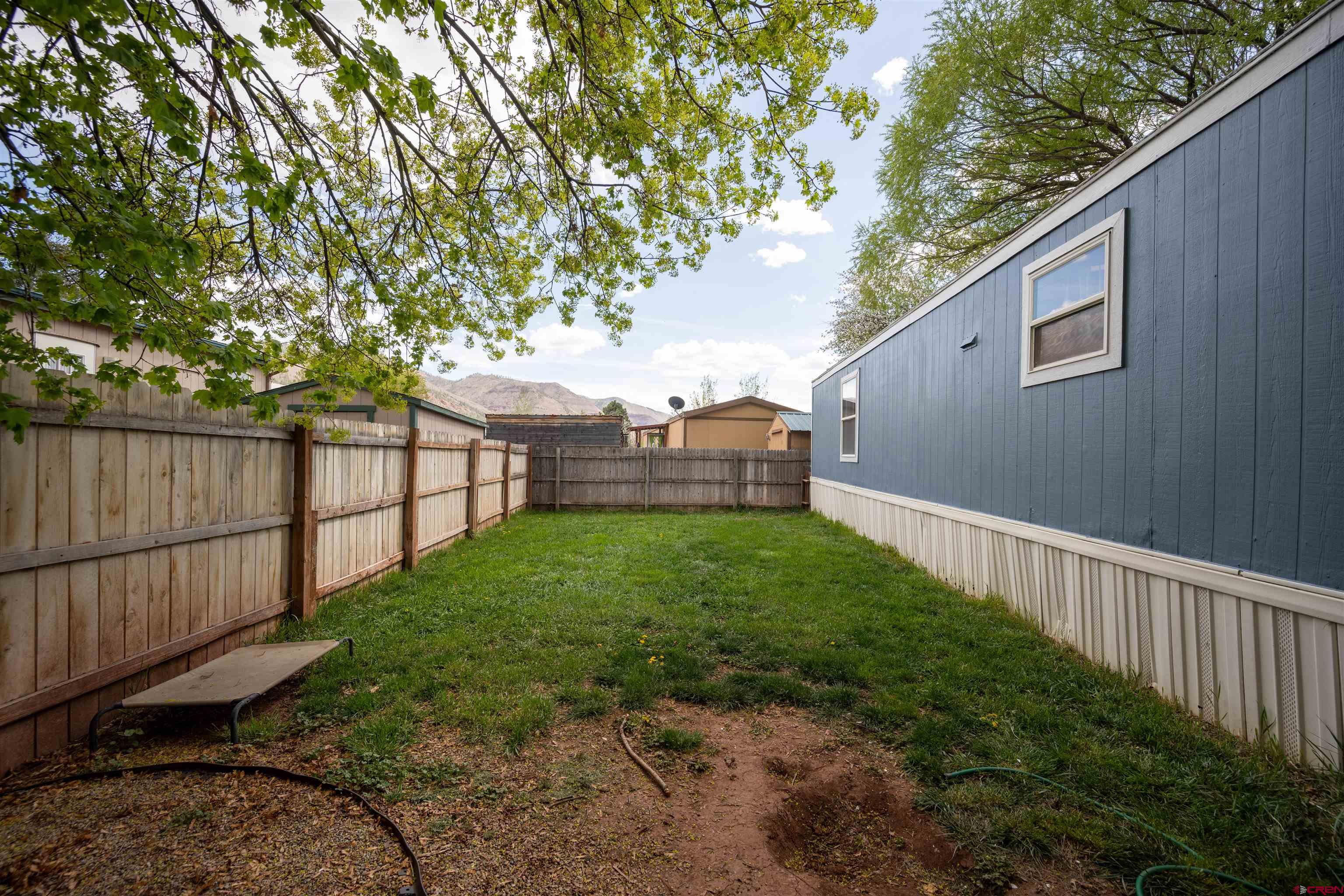 2 Mulberry Way Durango, CO 81301 - Photo 36 of 40 a view of a backyard with wooden fence and a couple of flower plants