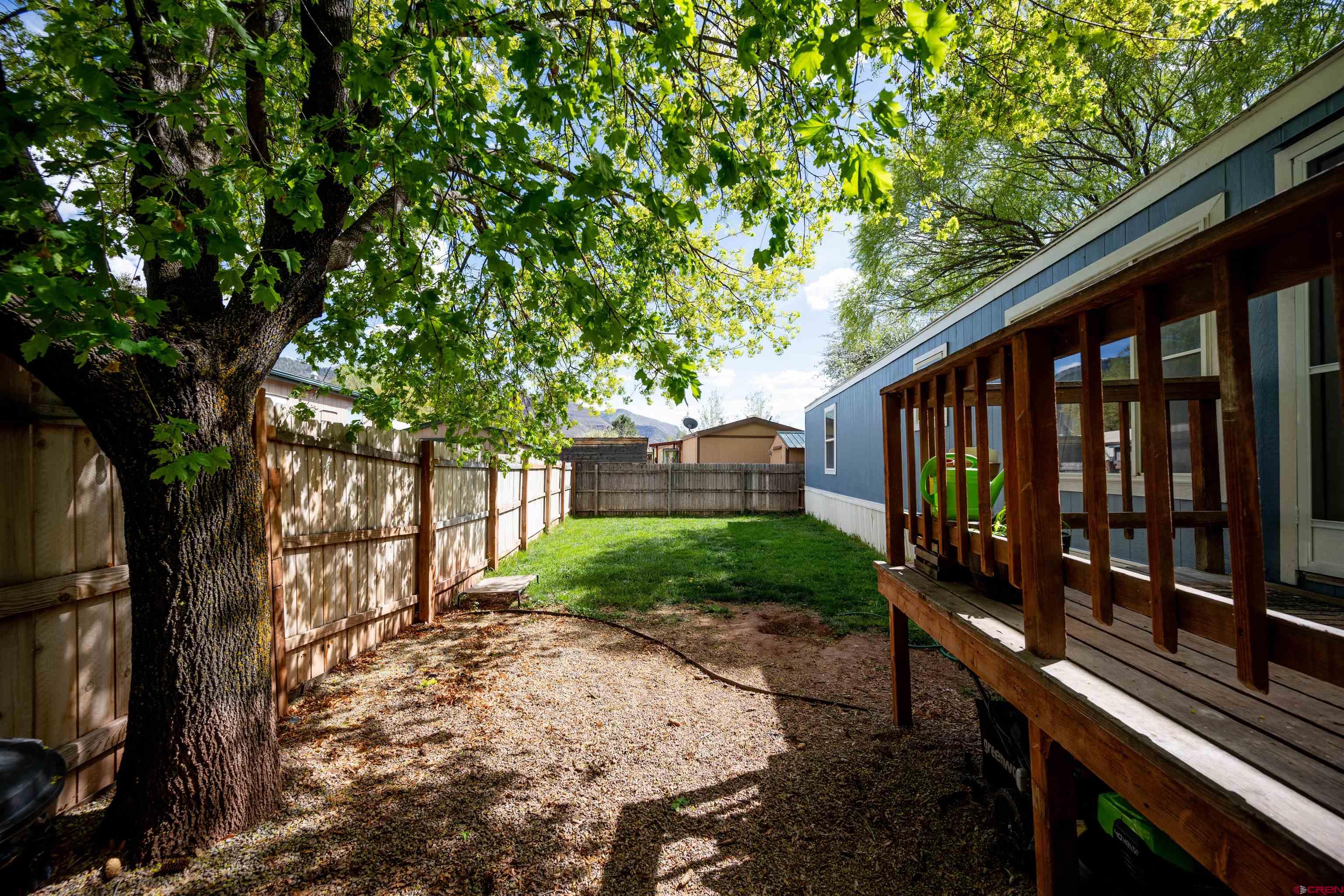 2 Mulberry Way Durango, CO 81301 - Photo 40 of 40 a view of a backyard with wooden fence and large trees